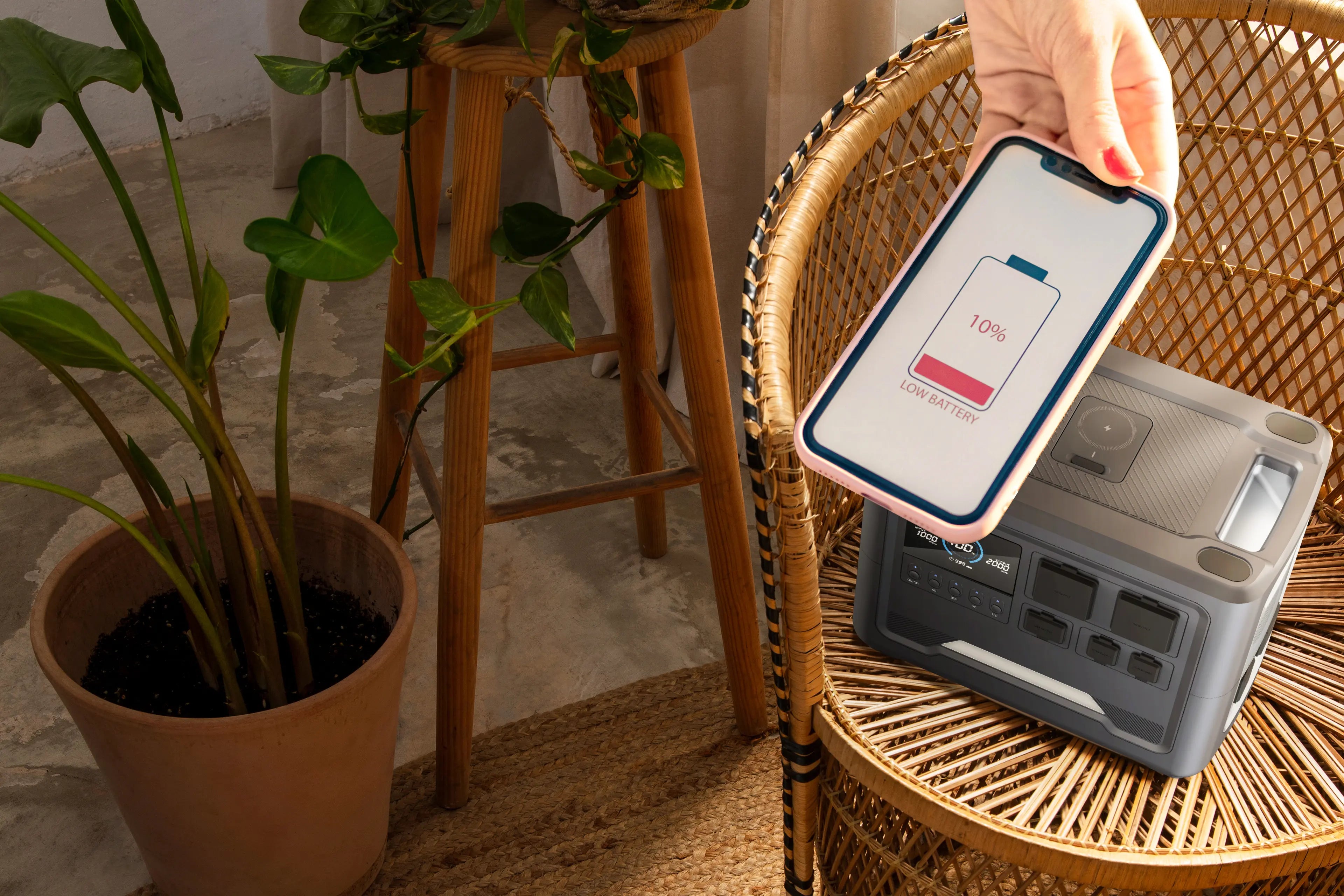 A sleek Rinecopo 170W portable power bank featuring its signature integrated braided orange USB-C cables, standing on a minimalist wooden surface. The smart digital display shows a high battery percentage, emphasizing its readiness for heavy-duty charging.